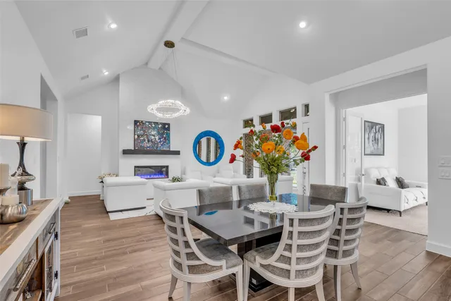 a room with pool table and windows
