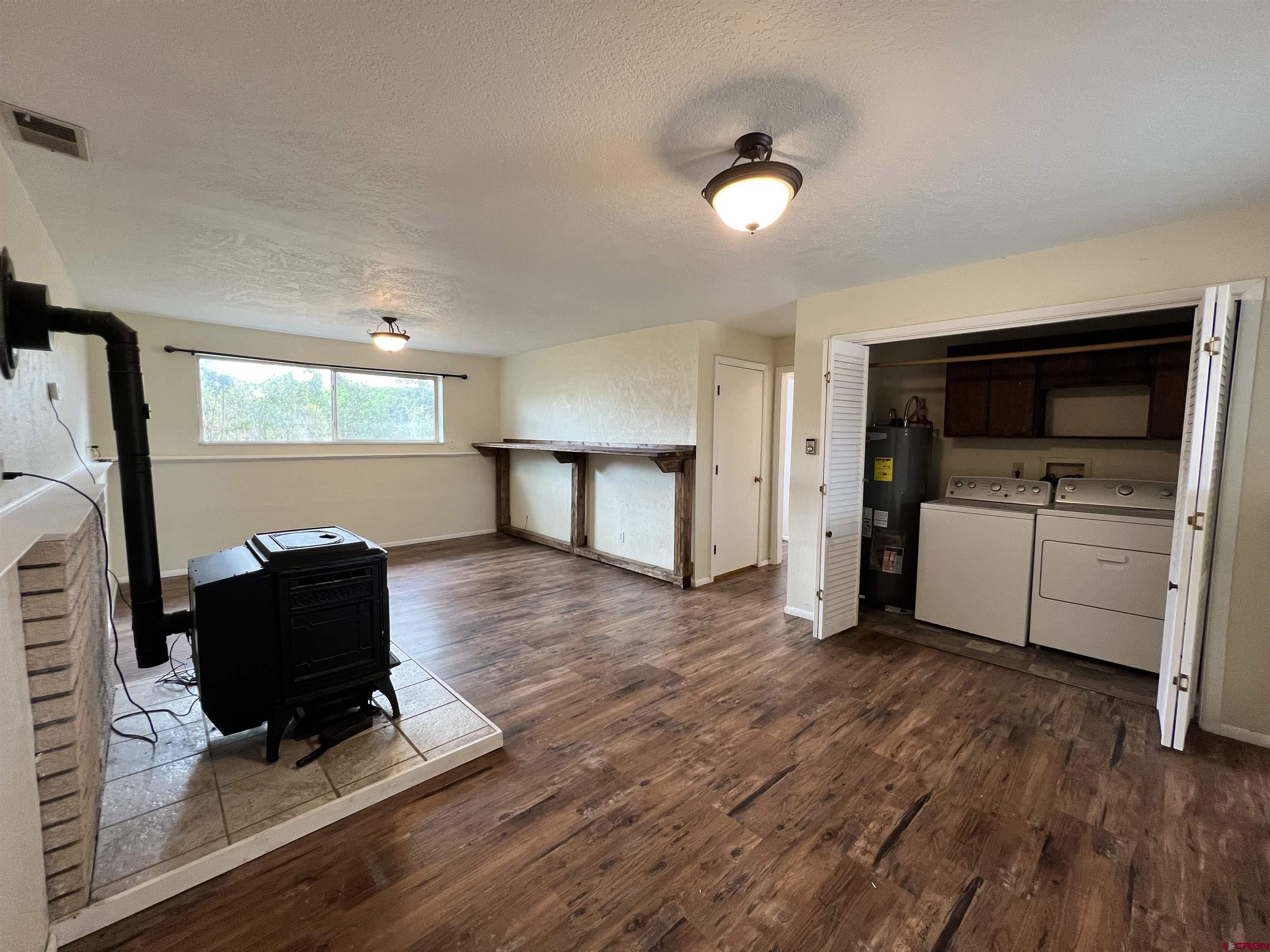 1328 Jackson Street Cortez, CO 81321 - Photo 25 of 37 a living room with a couch and a flat screen tv
