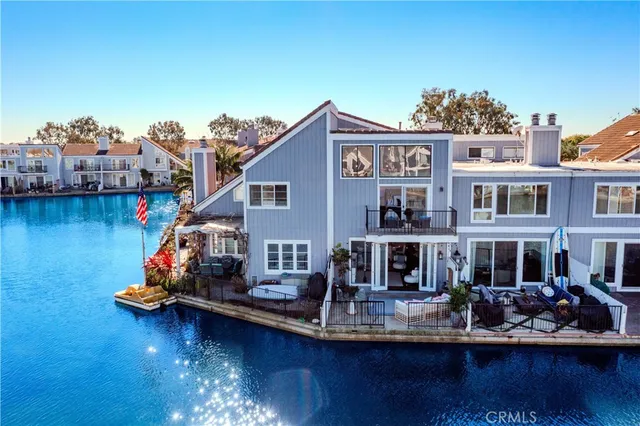 a front view of a house with swimming pool table and chairs