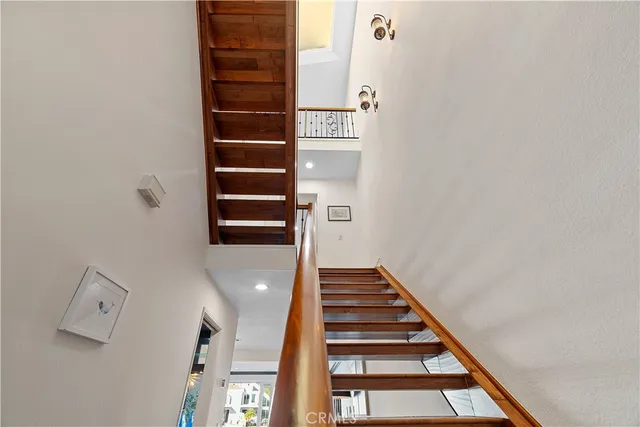 a spacious bedroom with a bed and wooden floor