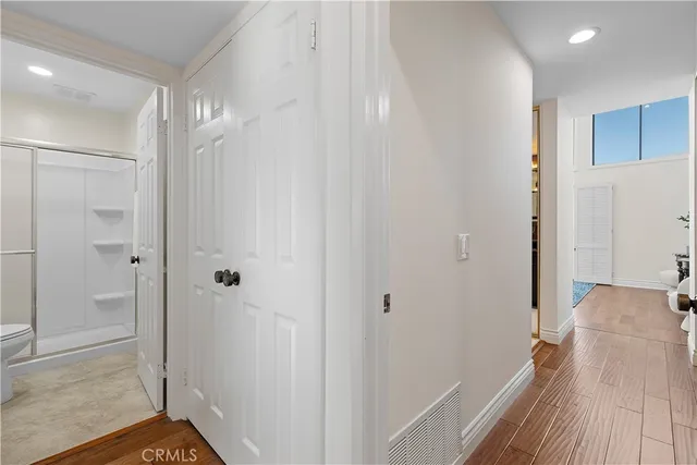 a bedroom with a bed and a potted plant
