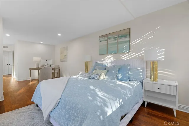 a bed room with a bed and a painting on the wall