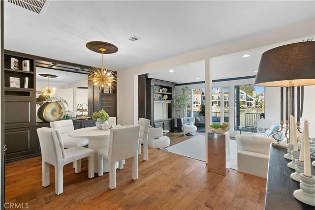 a view of a dining room with furniture wooden floor and chandelier