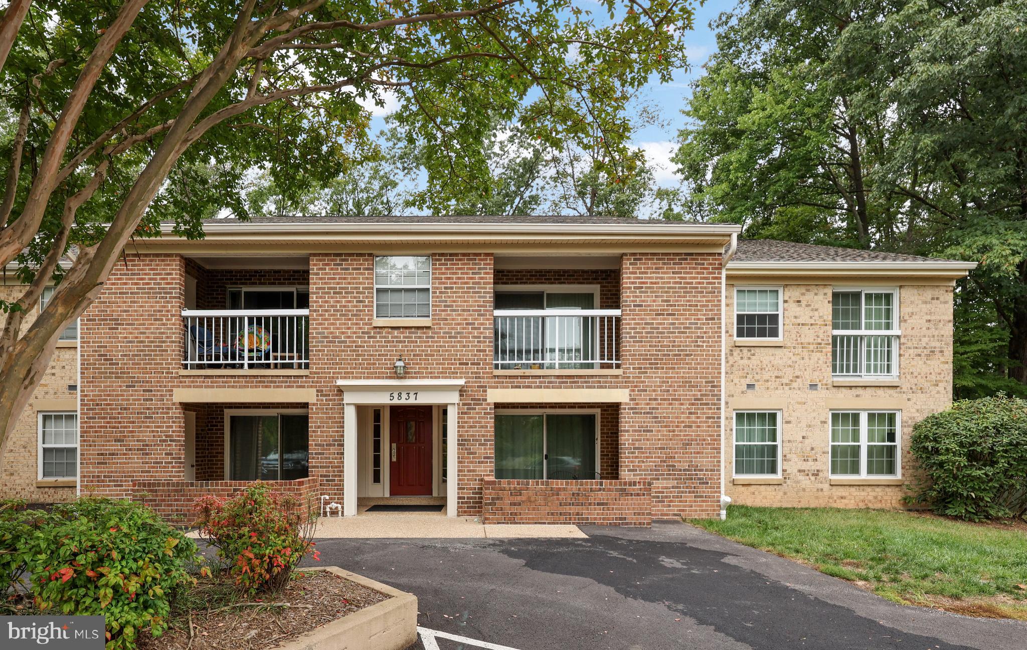 5837 Cove Landing Road, Unit 101 Burke, VA 22015 - Photo 1 of 35 a front view of a house with a yard