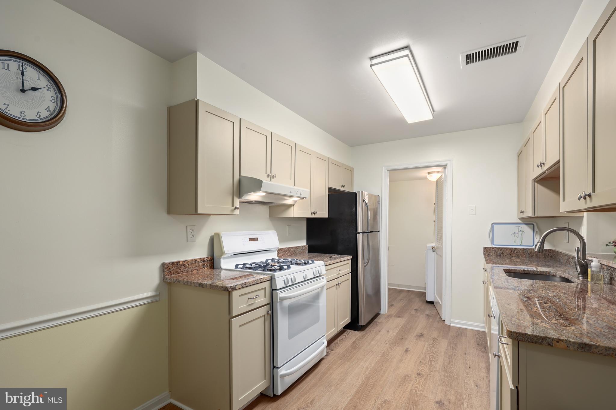 5837 Cove Landing Road, Unit 101 Burke, VA 22015 - Photo 11 of 35 a kitchen with a sink cabinets and appliances