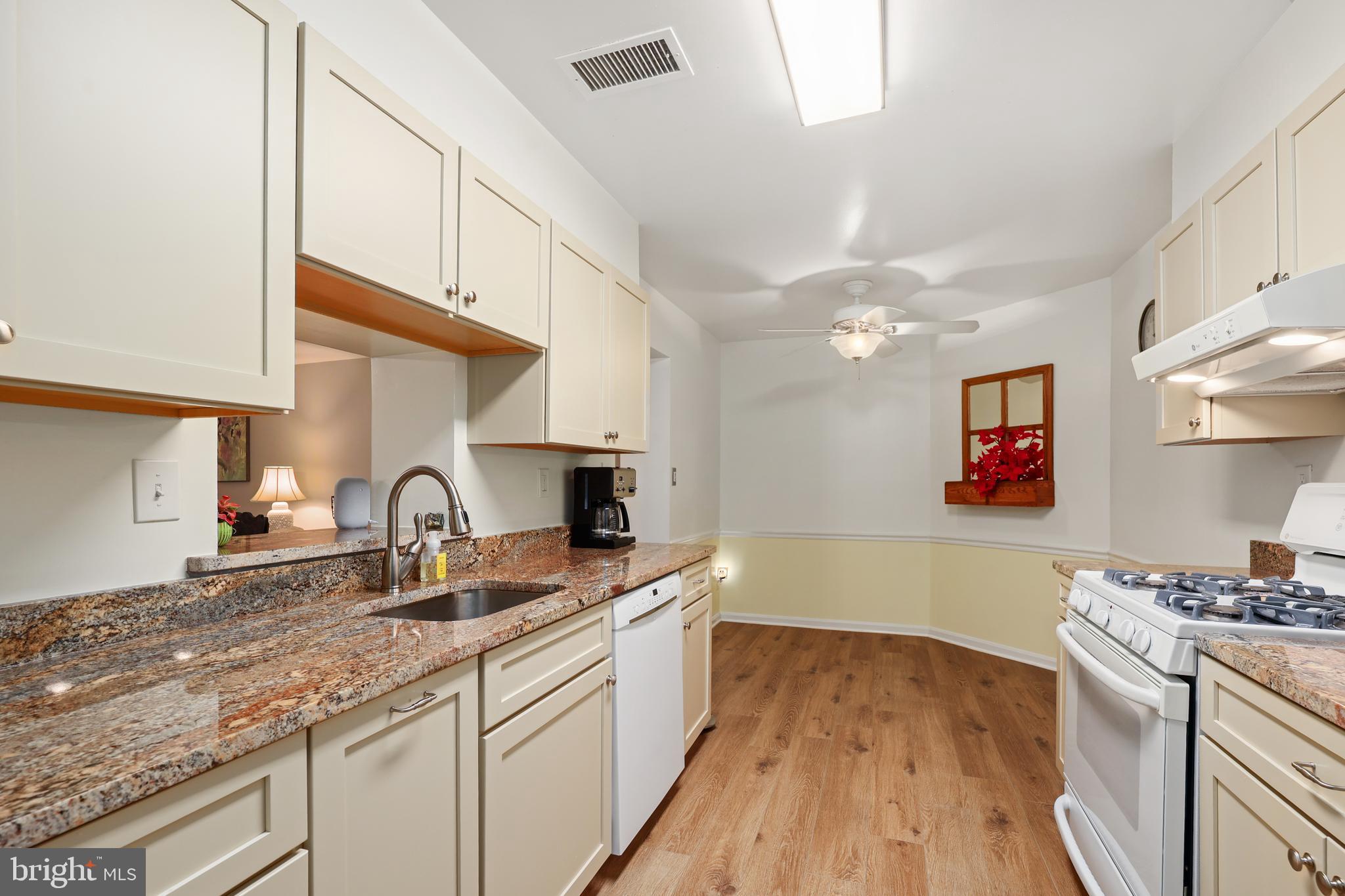 5837 Cove Landing Road, Unit 101 Burke, VA 22015 - Photo 12 of 35 a kitchen with a sink cabinets and wooden floor