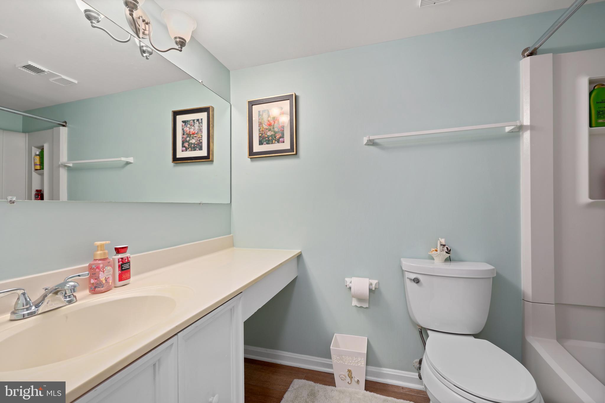 5837 Cove Landing Road, Unit 101 Burke, VA 22015 - Photo 16 of 35 a bathroom with a sink a toilet and a mirror