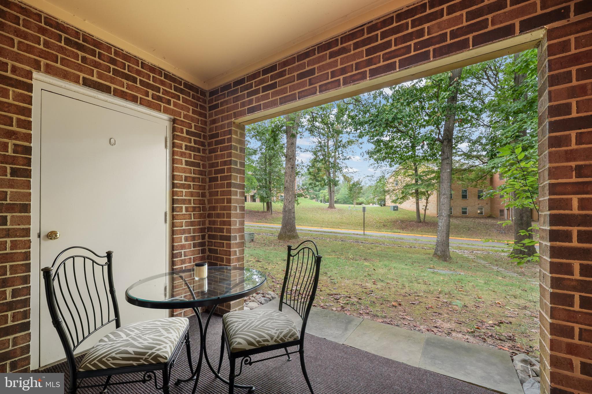5837 Cove Landing Road, Unit 101 Burke, VA 22015 - Photo 22 of 35 a view of a porch with furniture and garden