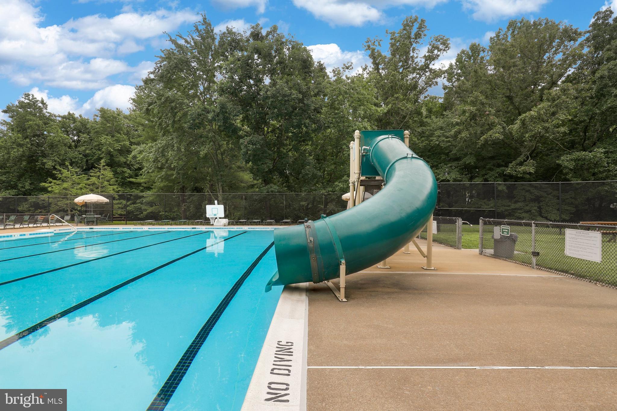 5837 Cove Landing Road, Unit 101 Burke, VA 22015 - Photo 25 of 35 a green field with lots of trees in the background