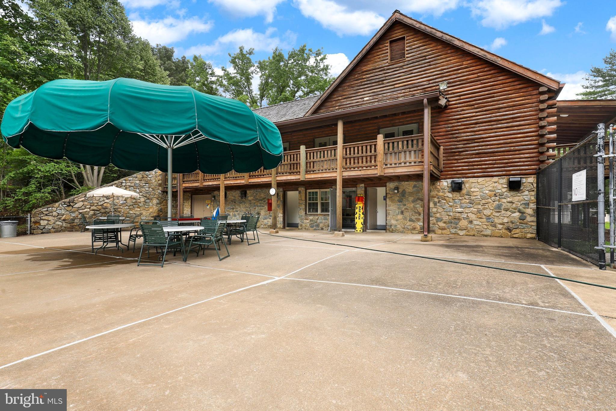 5837 Cove Landing Road, Unit 101 Burke, VA 22015 - Photo 27 of 35 a view of a house with a patio and a yard