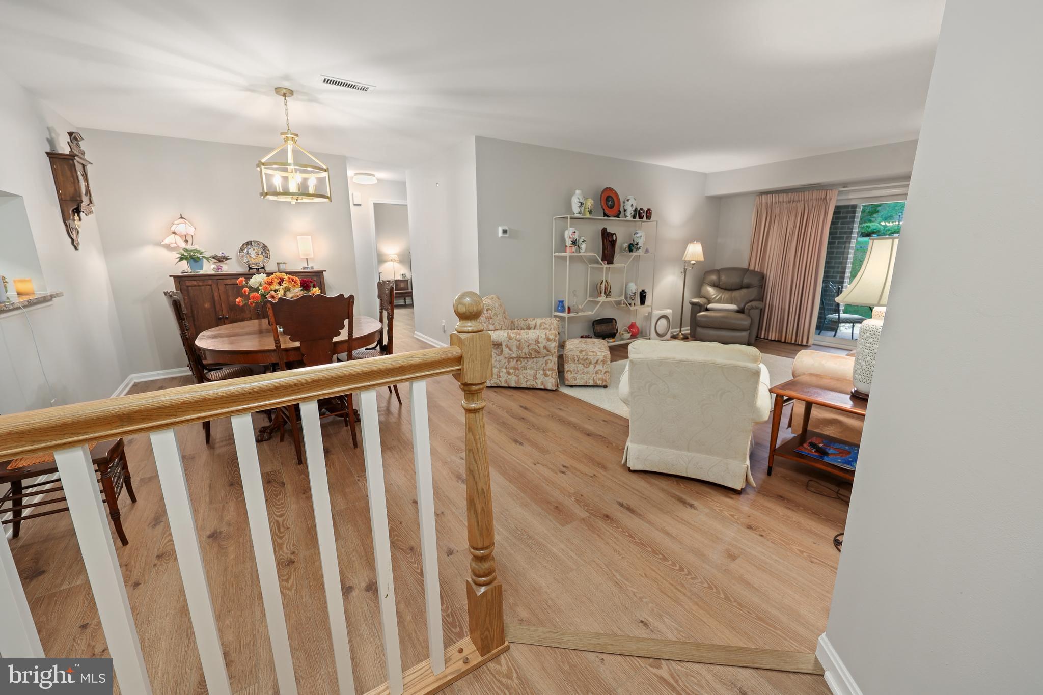 5837 Cove Landing Road, Unit 101 Burke, VA 22015 - Photo 4 of 35 a living room with furniture and a wooden floor