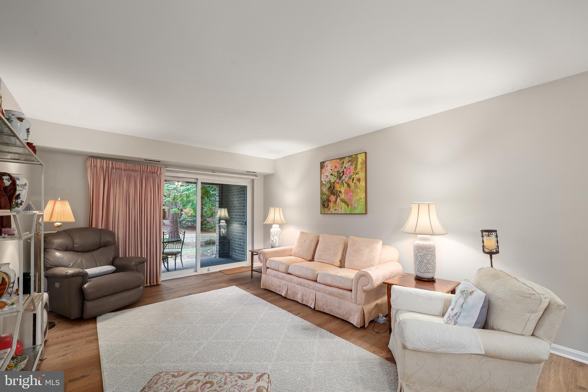 5837 Cove Landing Road, Unit 101 Burke, VA 22015 - Photo 5 of 35 a living room with furniture and a large window