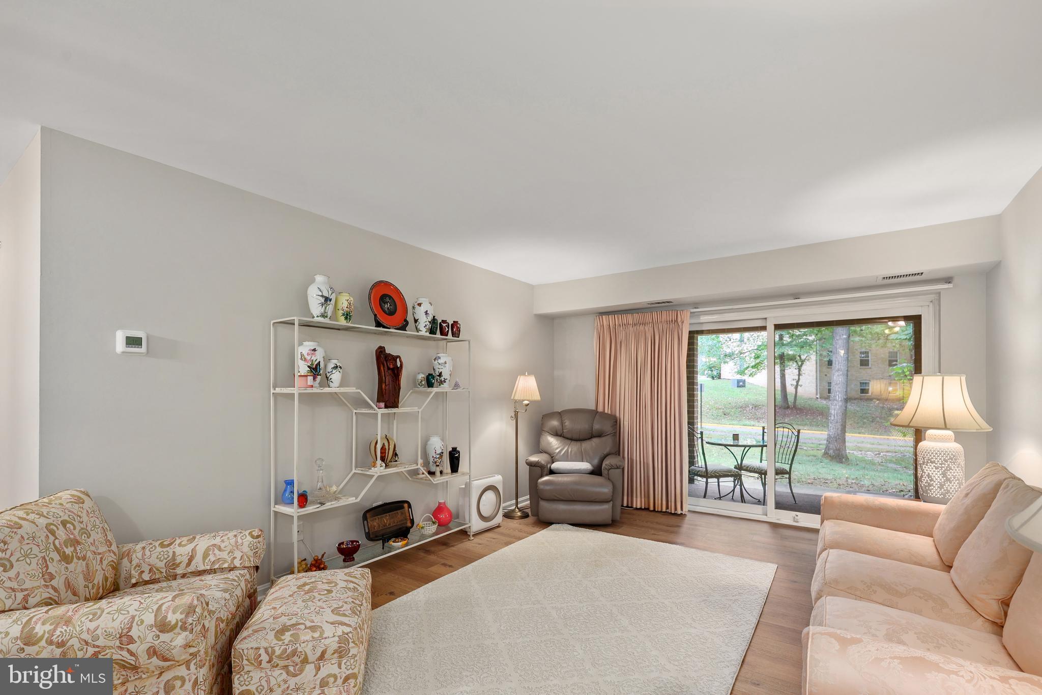 5837 Cove Landing Road, Unit 101 Burke, VA 22015 - Photo 6 of 35 a bedroom with furniture and a large window