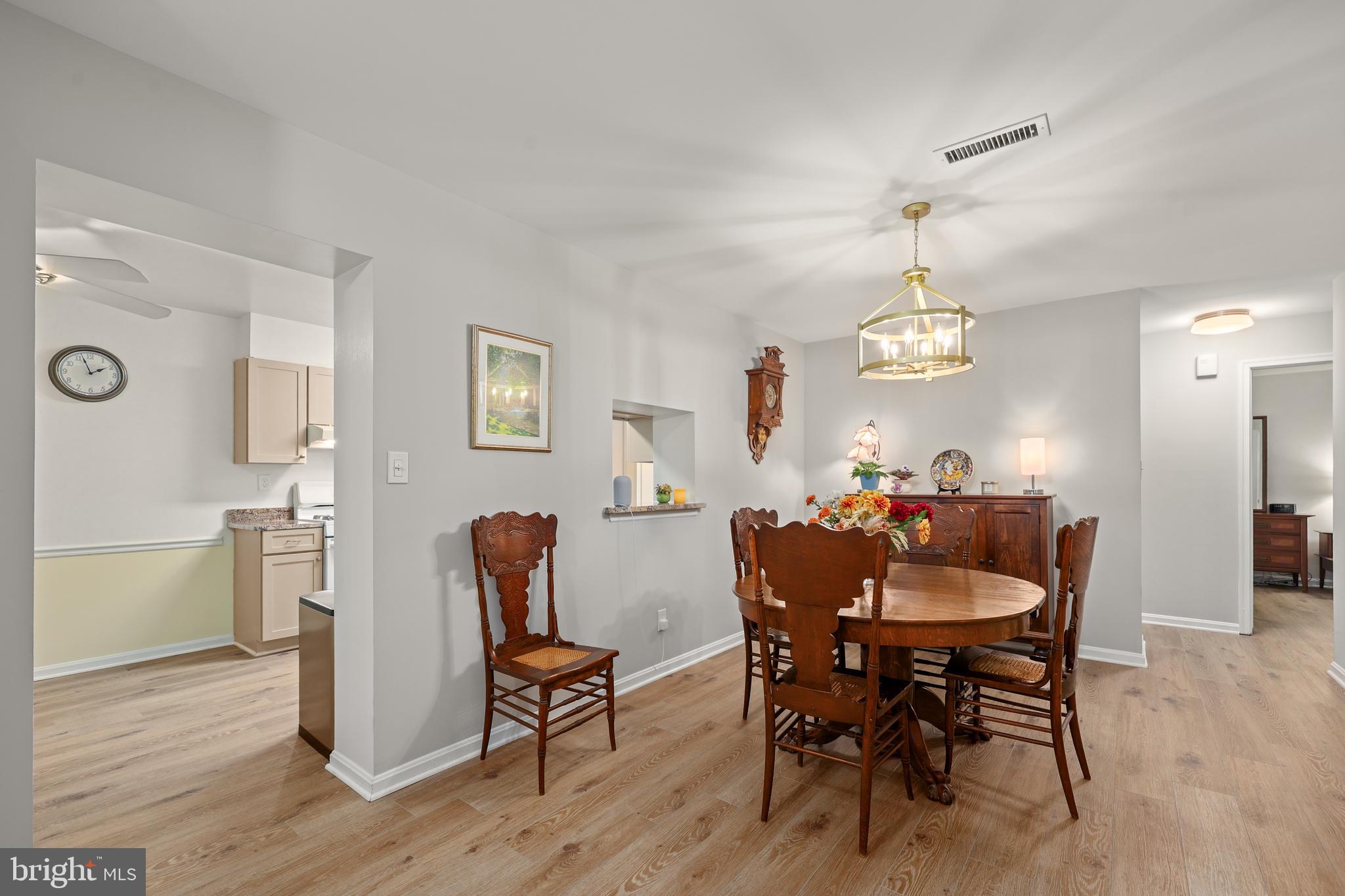 5837 Cove Landing Road, Unit 101 Burke, VA 22015 - Photo 8 of 35 a view of a dining room with furniture and wooden floor