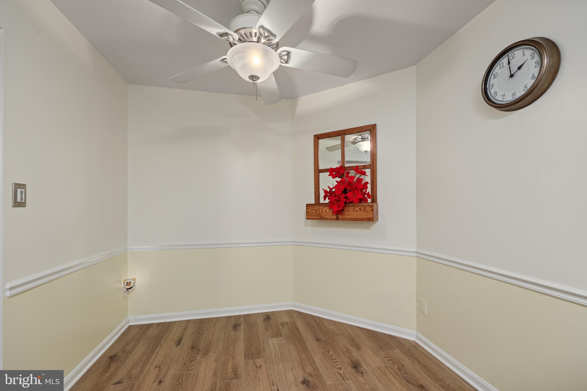 5837 Cove Landing Road, Unit 101 Burke, VA 22015 - Photo 10 of 35 a view of a hallway with paintings on the wall
