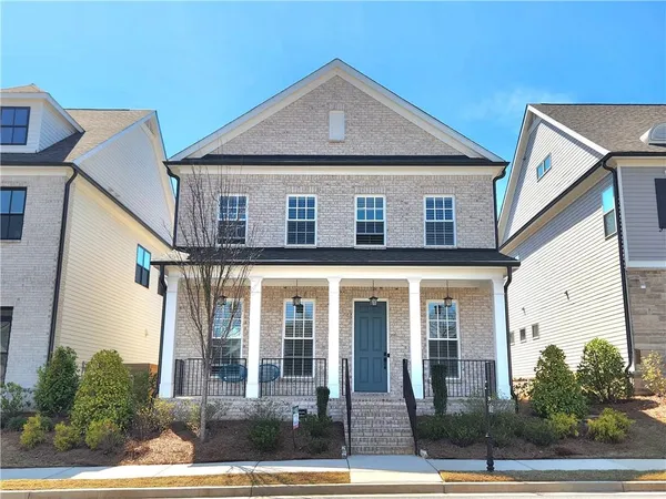 a front view of a house with a yard