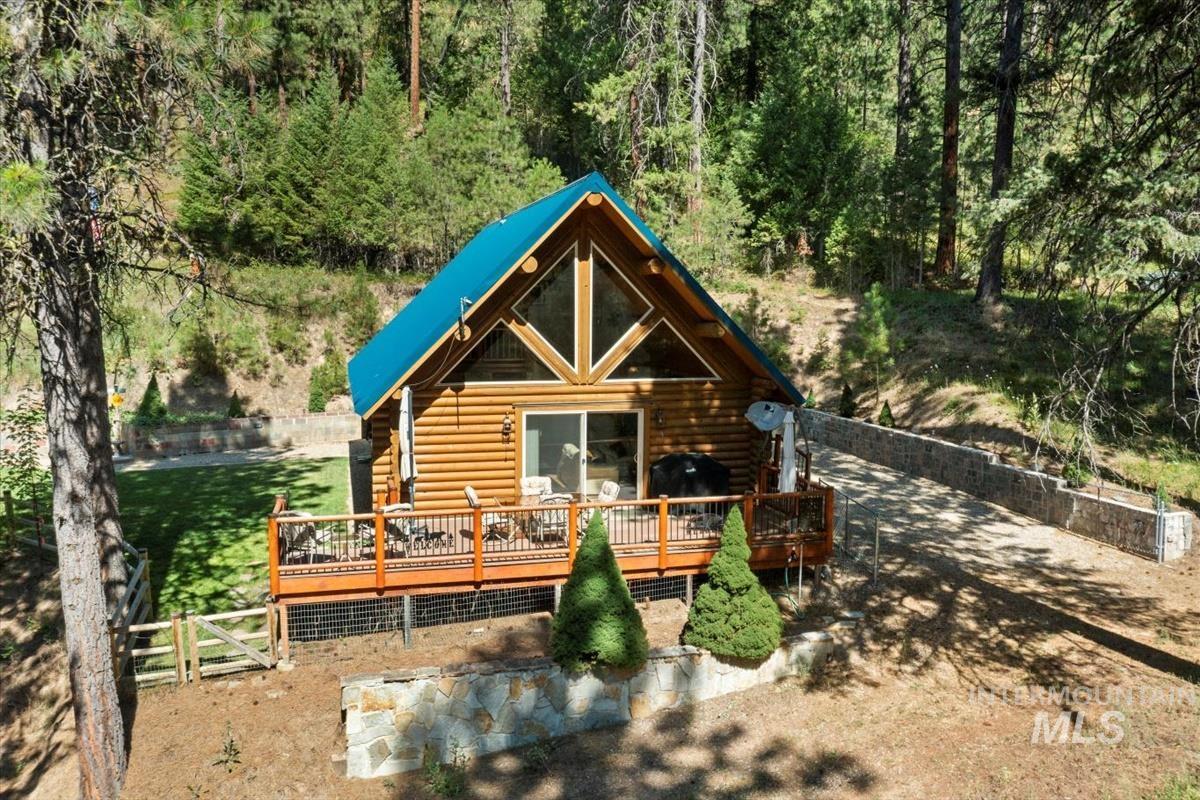 10 Elk Point Road Garden Valley, ID 83622 - Photo 2 of 42 View of front of home featuring a wooden deck and log siding
