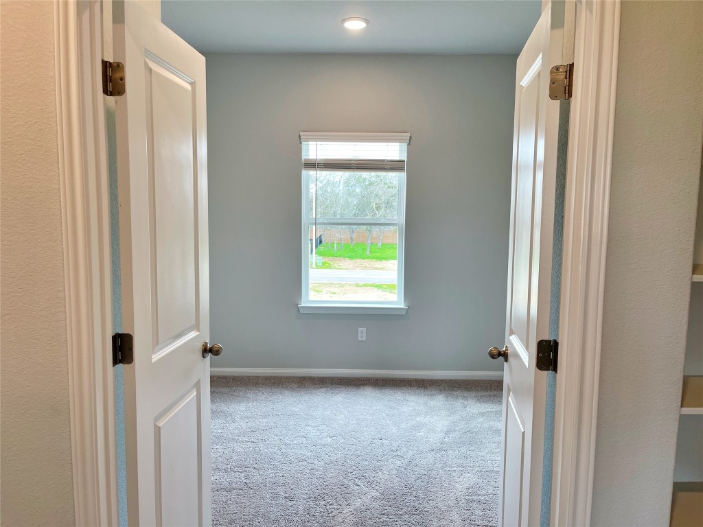 143 Delaware Lane Kyle, TX 78640 - Photo 12 of 30 a view of an empty room with a window