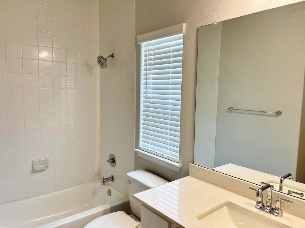 143 Delaware Lane Kyle, TX 78640 - Photo 16 of 30 a bathroom with a sink and a mirror