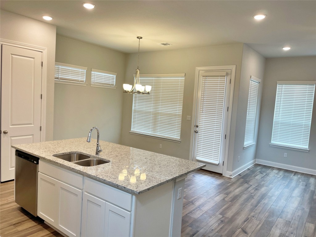 143 Delaware Lane Kyle, TX 78640 - Photo 4 of 30 a kitchen with a sink cabinets and wooden floor