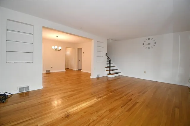 a view of a room with wooden floor and staircase