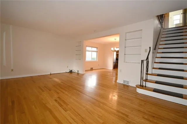 a view of a room with wooden floor and stairs