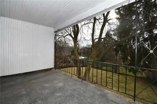 a view of balcony with yard and tree