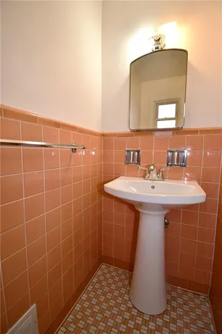 a bathroom with a sink a mirror and shower