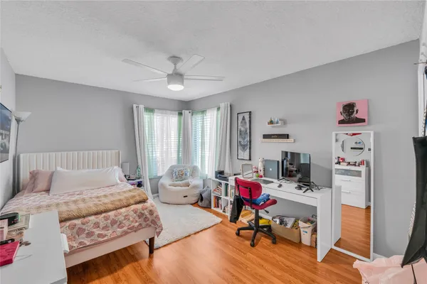 a bedroom with furniture and a wooden floor