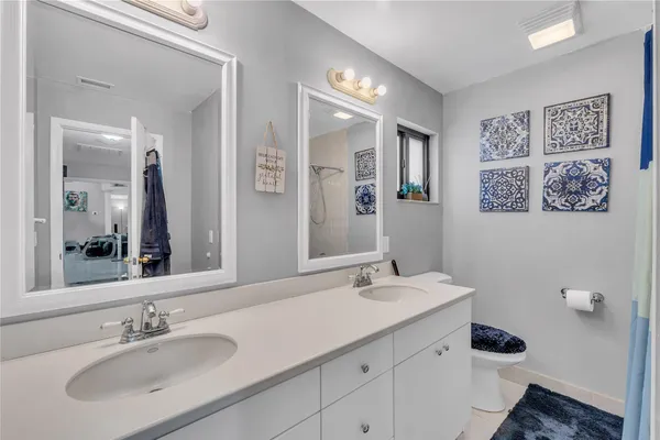 a bathroom with a double vanity sink and a mirror