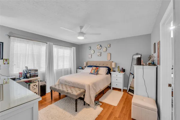 a bedroom with furniture and a large window