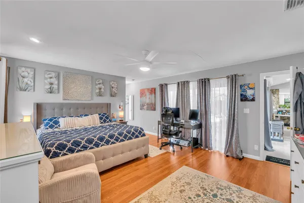 a bedroom with a bed furniture and wooden floor