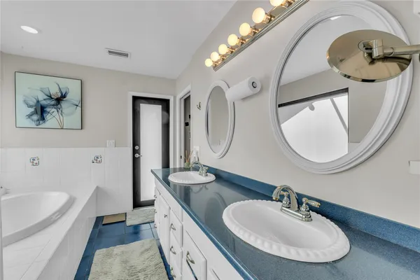 a bathroom with a double vanity sink and a mirror
