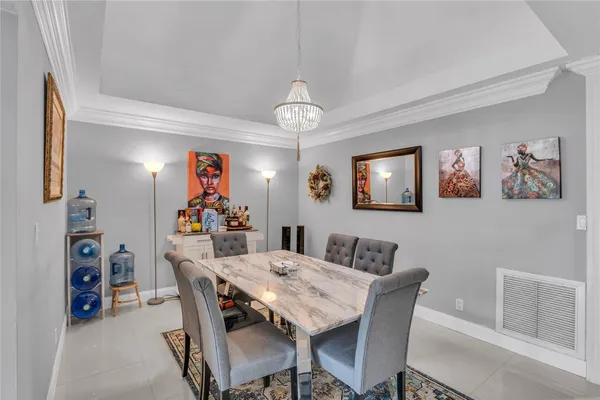 a view of a dining room with furniture and chandelier