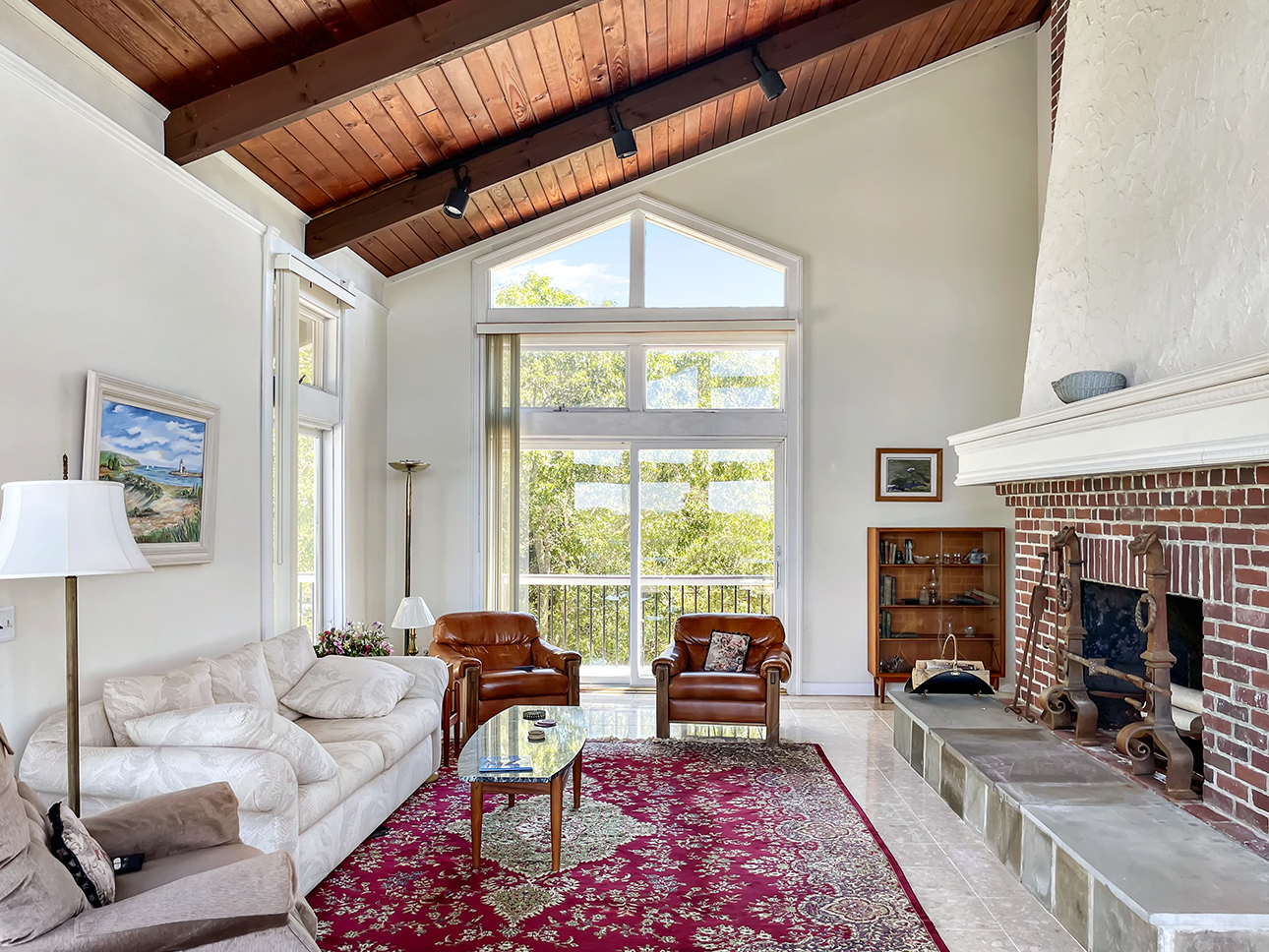 70 Capawock Road West Tisbury, MA 02568 - Photo 12 of 23 a living room with furniture a fireplace and a table