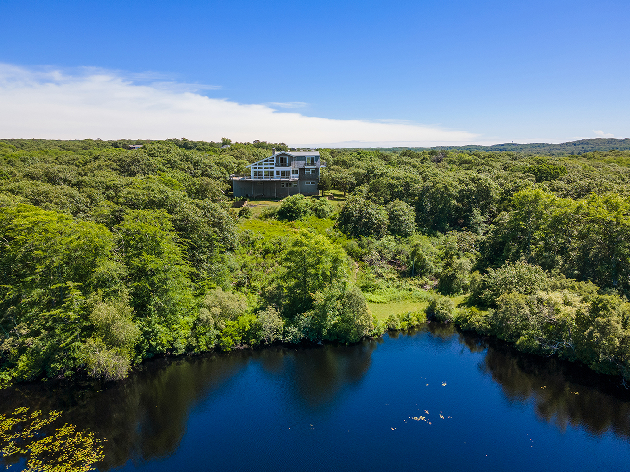 70 Capawock Road West Tisbury, MA 02568 - Photo 3 of 23 a view of a lake with houses in back