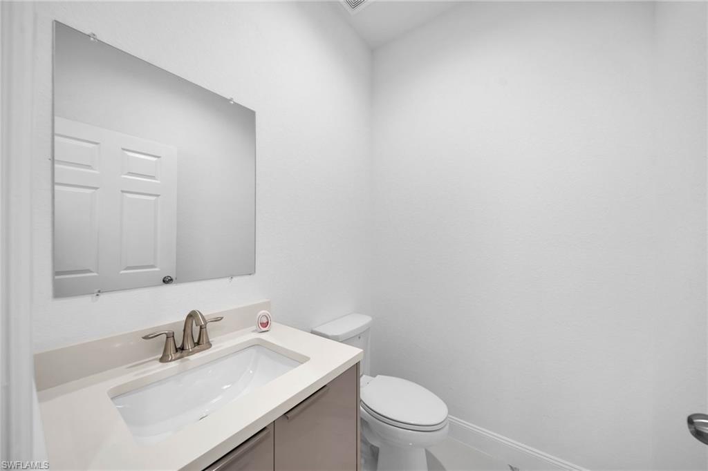 3804 40th Street Southwest Lehigh Acres, FL 33976 - Photo 11 of 24 a bathroom with a sink a toilet and mirror