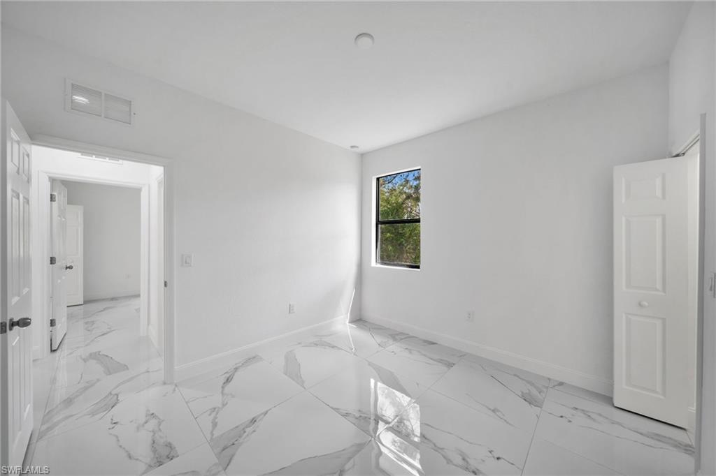 3804 40th Street Southwest Lehigh Acres, FL 33976 - Photo 17 of 24 an empty room with windows
