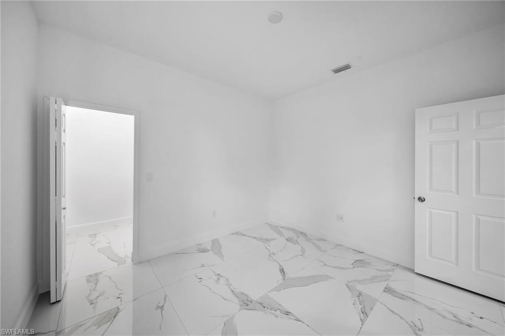 3804 40th Street Southwest Lehigh Acres, FL 33976 - Photo 19 of 24 an empty room with an entryway