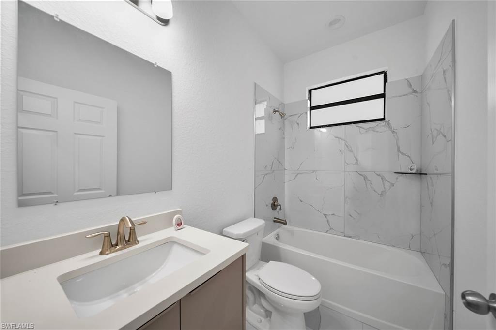 3804 40th Street Southwest Lehigh Acres, FL 33976 - Photo 20 of 24 a bathroom with a sink a toilet and shower