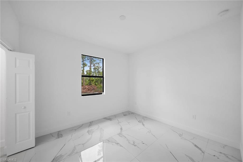 3804 40th Street Southwest Lehigh Acres, FL 33976 - Photo 21 of 24 an empty room with a window