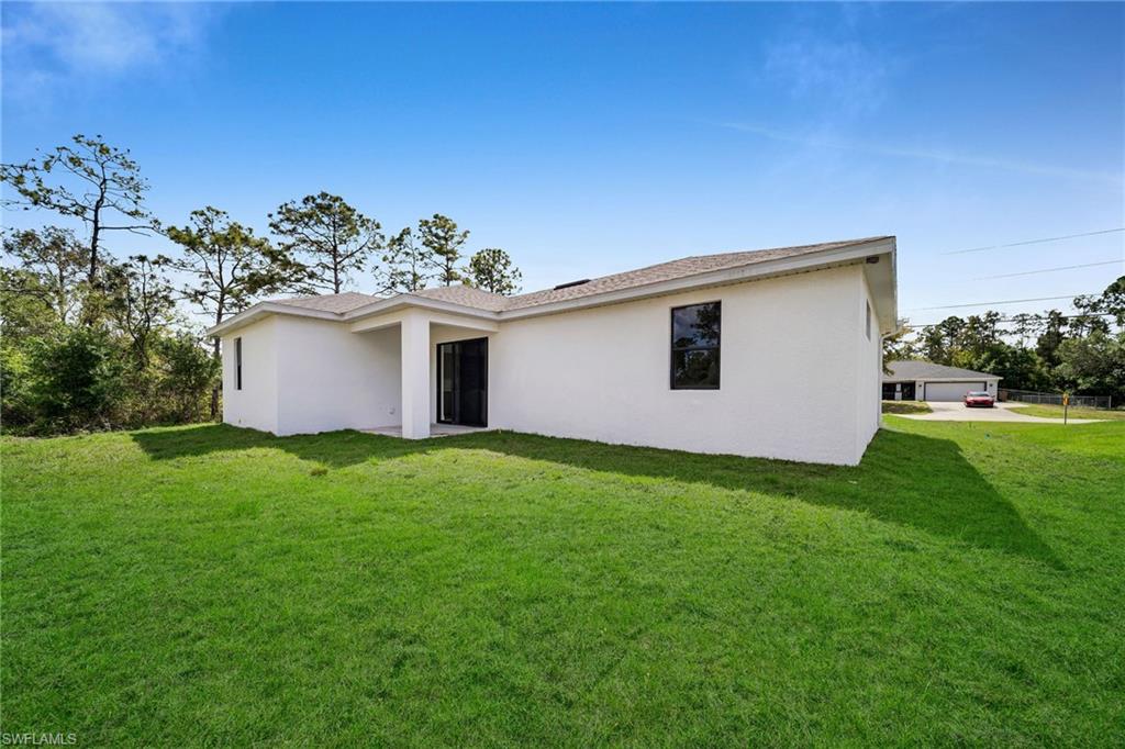 3804 40th Street Southwest Lehigh Acres, FL 33976 - Photo 23 of 24 a view of a house with a backyard