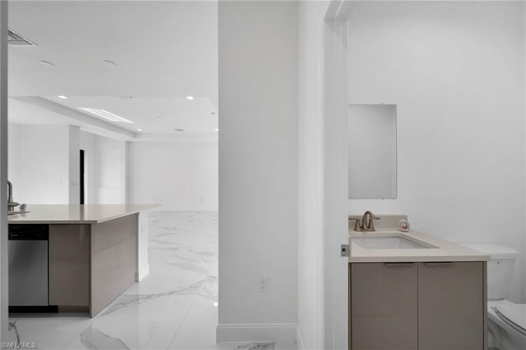 3804 40th Street Southwest Lehigh Acres, FL 33976 - Photo 9 of 24 a bathroom with a sink and a mirror