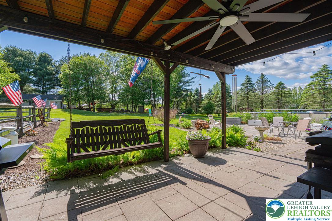 341 Lower Greenhill Road Kunkletown, PA 18058 - Photo 46 of 69 A spacious covered patio provides a delightful outdoor living area overlooking the lush green yard and pool.