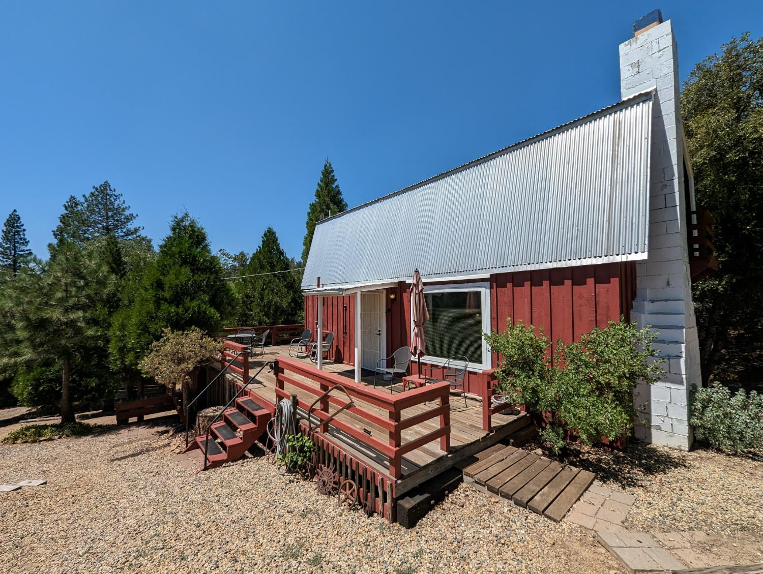 a view of a backyard with a sitting area barbeque oven and a garden