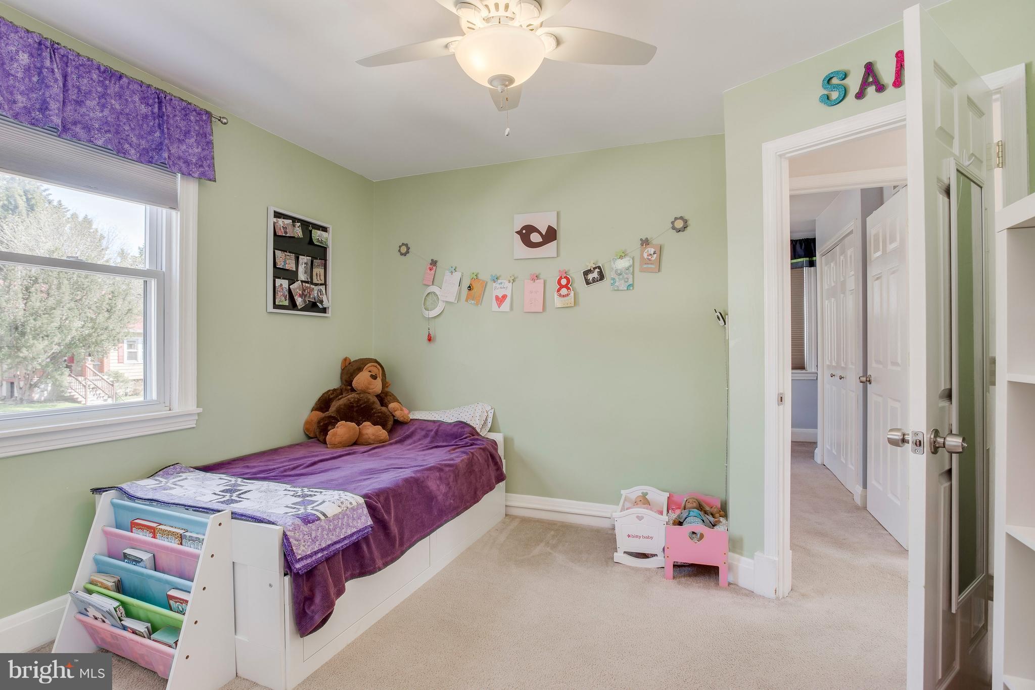 1121 Overbrook Road Baltimore, MD 21239 - Photo 22 of 49 a bedroom with a bed and a chandelier