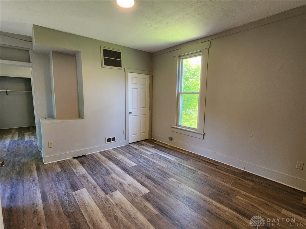 211 Race Street Spring Valley, OH 45370 - Photo 6 of 12 This spacious room features ample natural light and durable flooring, perfect for a versatile living space.