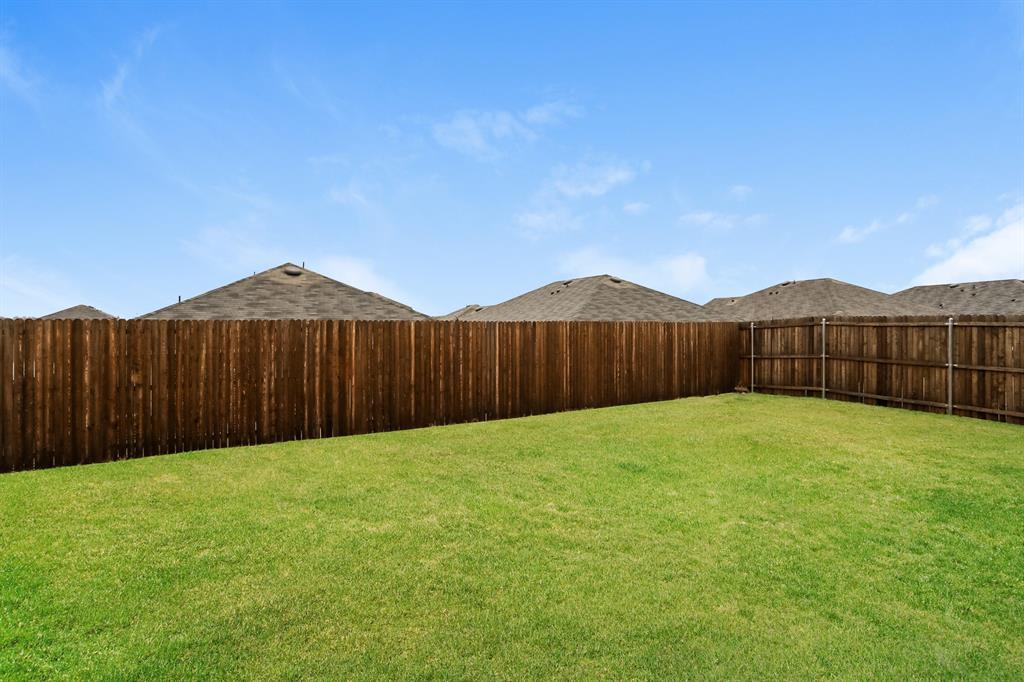 3113 Parsons Street Fate, TX 75189 - Photo 14 of 15 a view of a backyard with wooden fence