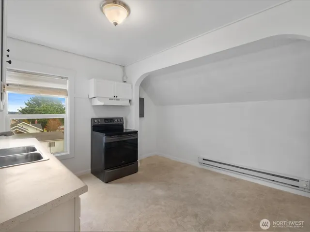 a kitchen with a stove and a refrigerator