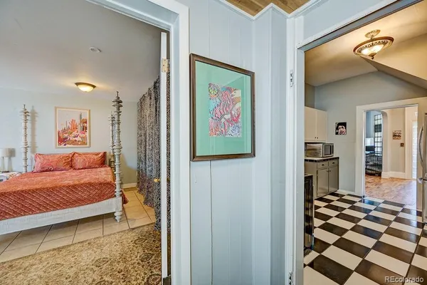 a view of a hallway with wooden floor and furniture